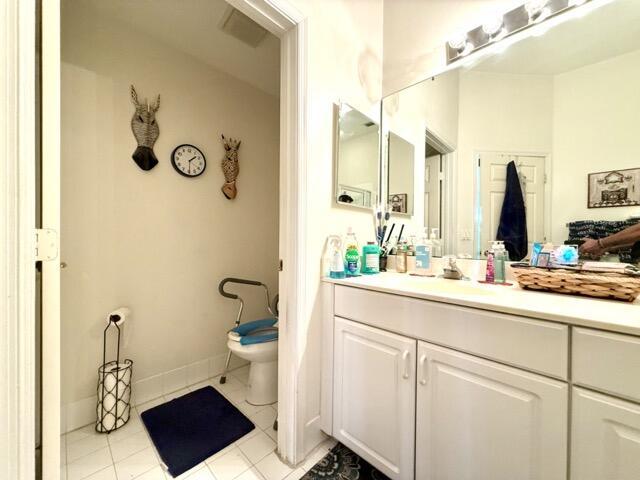 bathroom with vanity, tile patterned floors, and toilet