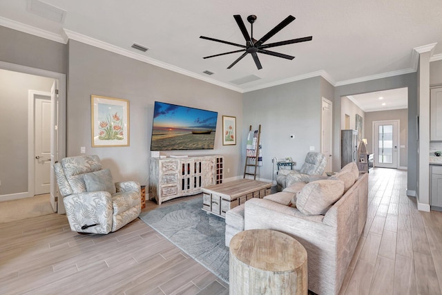 living room with ceiling fan, ornamental molding, and light wood-type flooring