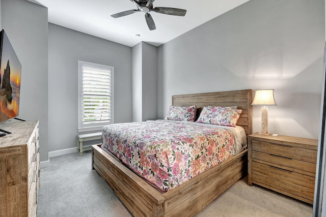 bedroom featuring light carpet and ceiling fan