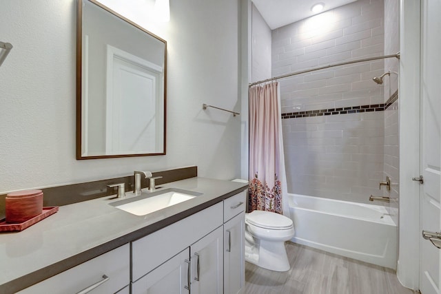 full bathroom featuring toilet, vanity, and shower / bathtub combination with curtain