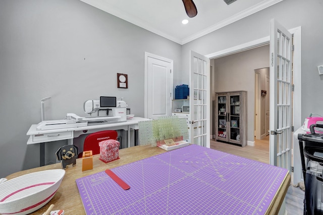 bedroom with crown molding, light hardwood / wood-style flooring, ceiling fan, and french doors