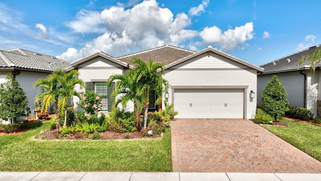 ranch-style home with a garage and a front yard