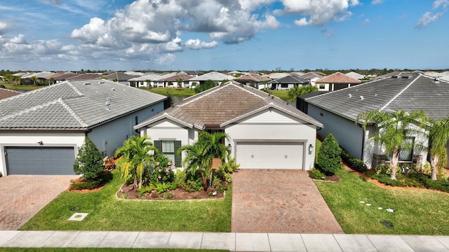 single story home with a garage and a front lawn