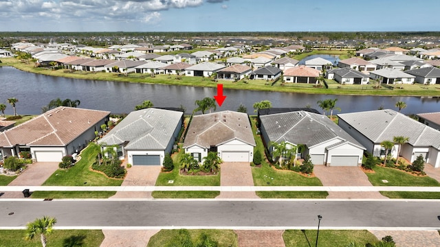 birds eye view of property with a water view