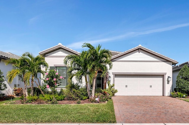 ranch-style house with a garage and a front lawn