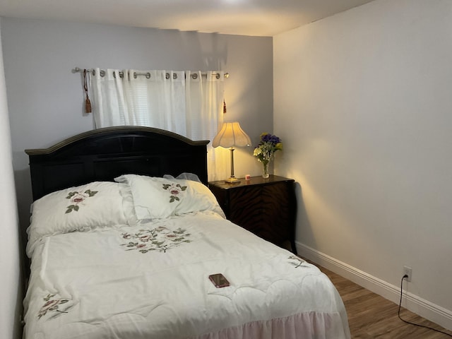 bedroom with hardwood / wood-style flooring