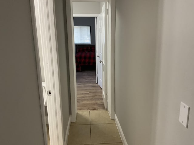 corridor featuring light tile patterned floors