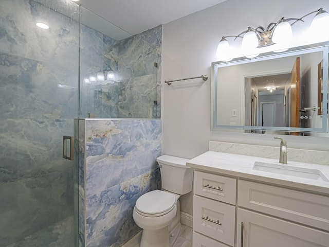 bathroom with vanity, toilet, and walk in shower