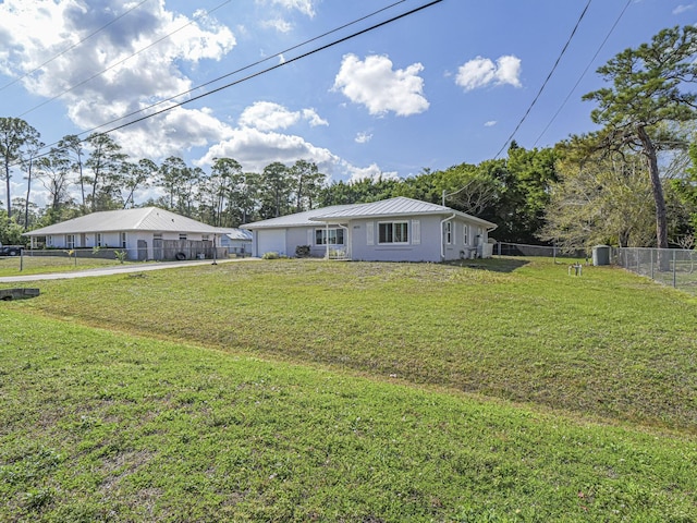 ranch-style home with a garage and a front lawn