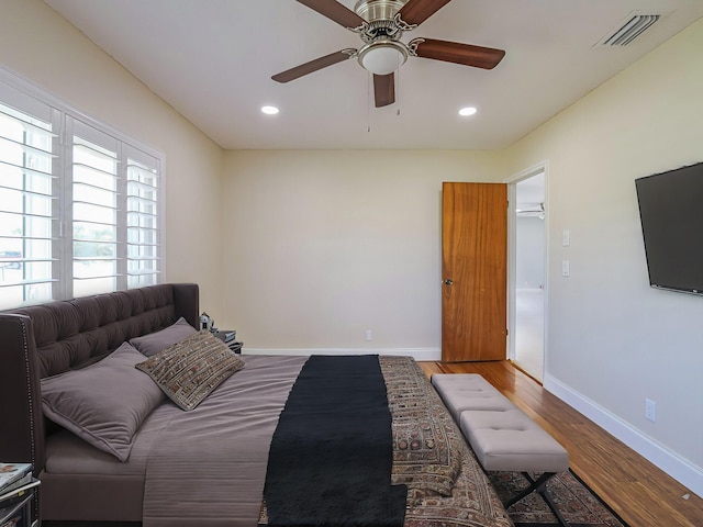 bedroom with wood-type flooring and ceiling fan