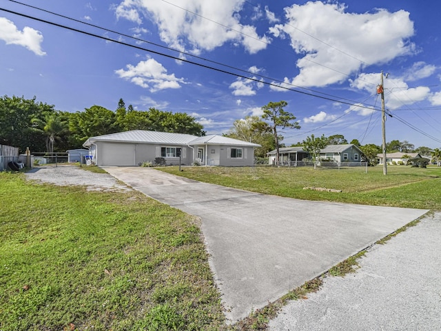 single story home featuring a garage and a front lawn