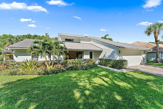 view of front of home featuring a garage and a front yard