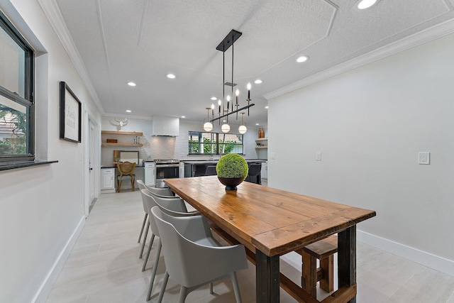 dining area with ornamental molding and a textured ceiling