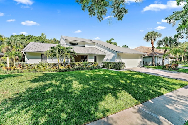 view of front of property with a garage and a front yard