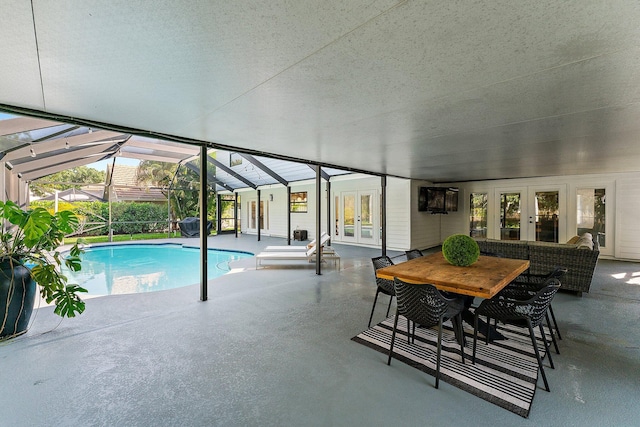 view of swimming pool featuring french doors