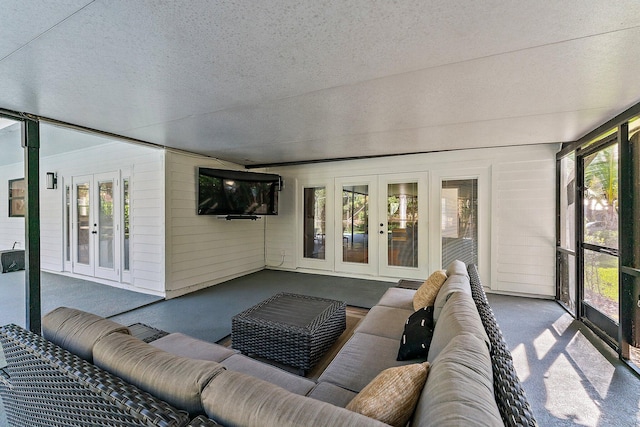 sunroom / solarium featuring french doors