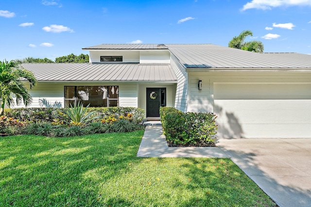 view of front of house with a garage and a front yard