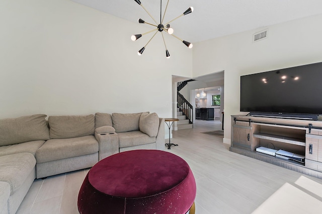 living room with high vaulted ceiling and an inviting chandelier