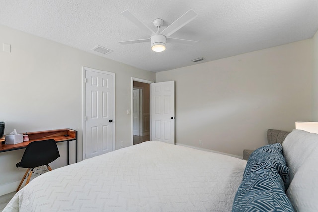 bedroom with a textured ceiling and ceiling fan