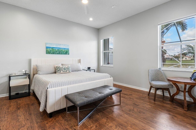 bedroom featuring dark hardwood / wood-style floors and a textured ceiling