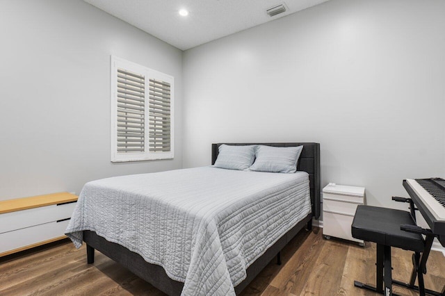 bedroom featuring dark hardwood / wood-style flooring