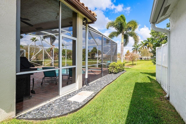 view of yard with a patio area and glass enclosure