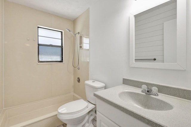 bathroom featuring vanity, toilet, and walk in shower