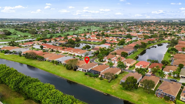 drone / aerial view featuring a water view and a residential view