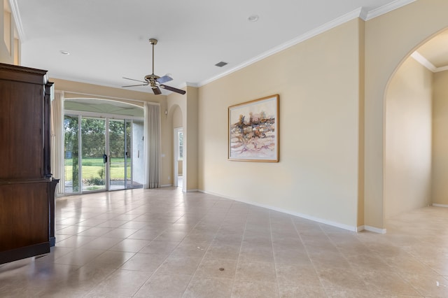 spare room with baseboards, arched walkways, a ceiling fan, and ornamental molding