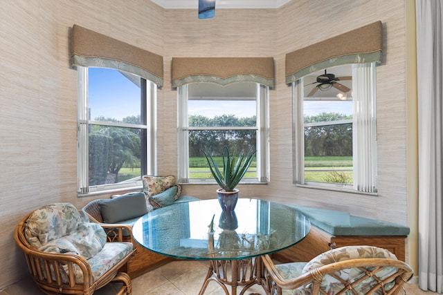 sitting room with tile patterned flooring and a ceiling fan