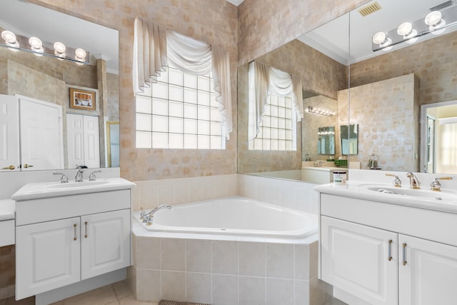 bathroom with visible vents, a sink, a garden tub, and wallpapered walls