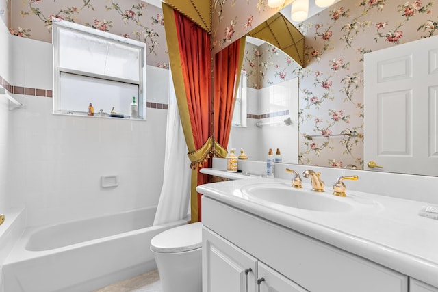 bathroom featuring shower / bath combination with curtain, vanity, toilet, and wallpapered walls