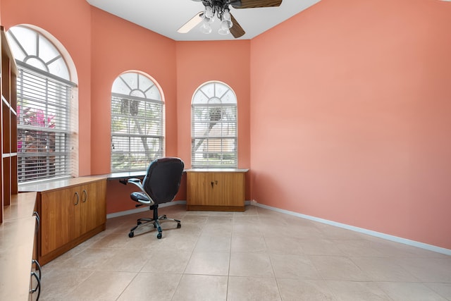 office space featuring ceiling fan, baseboards, and light tile patterned flooring