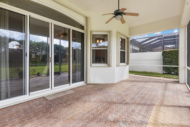 unfurnished sunroom with a ceiling fan