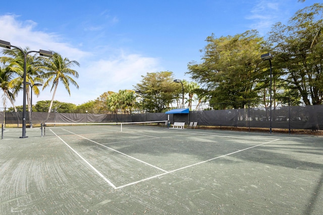 view of tennis court featuring fence