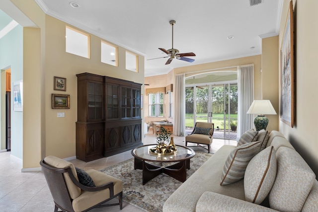 living area with light tile patterned floors, visible vents, ornamental molding, ceiling fan, and baseboards