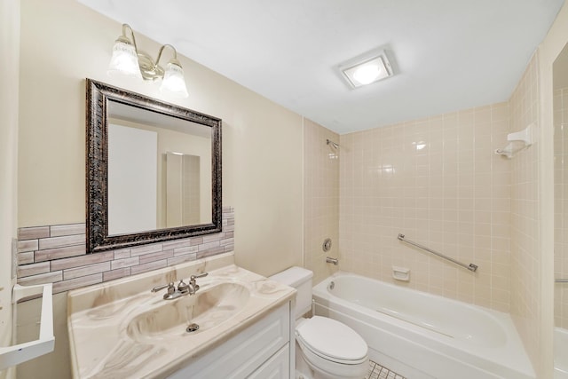 full bathroom featuring tiled shower / bath, vanity, and toilet