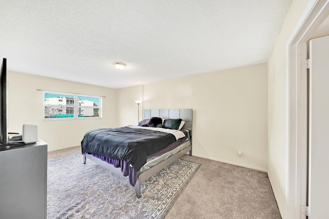 carpeted bedroom featuring a textured ceiling