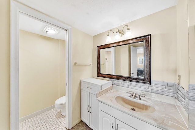 bathroom with vanity, backsplash, and toilet