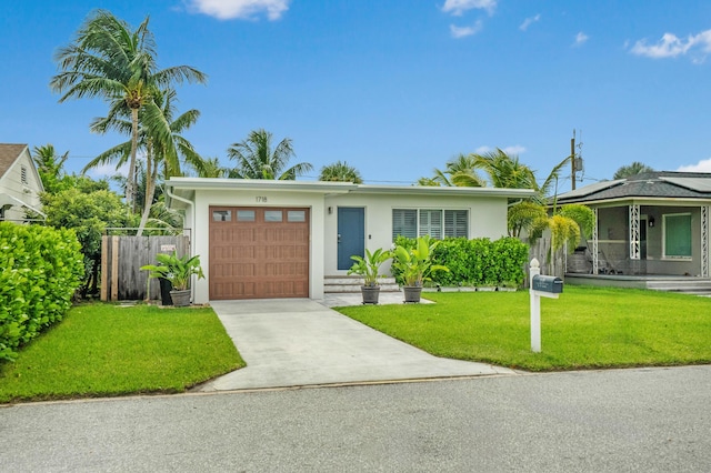 view of front of property featuring a garage and a front yard