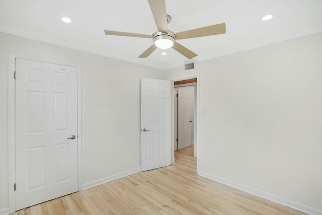 unfurnished bedroom with crown molding, ceiling fan, and light hardwood / wood-style flooring