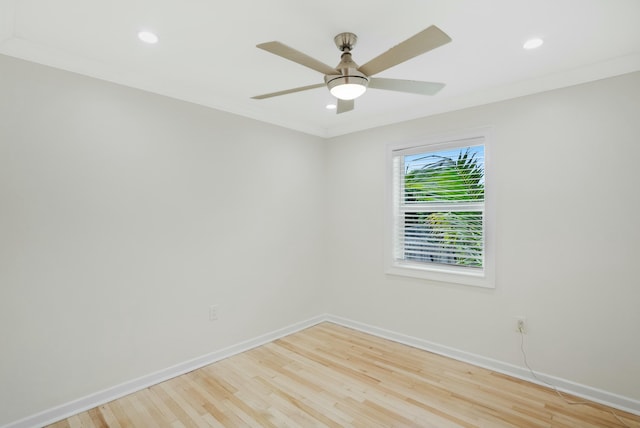 empty room with crown molding, light hardwood / wood-style floors, and ceiling fan