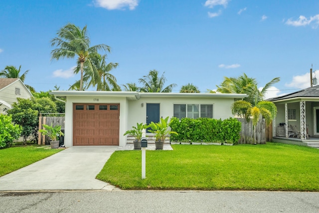 view of front of home with a garage and a front lawn