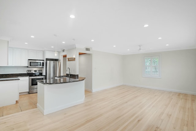 kitchen with decorative light fixtures, white cabinets, ornamental molding, light hardwood / wood-style floors, and stainless steel appliances