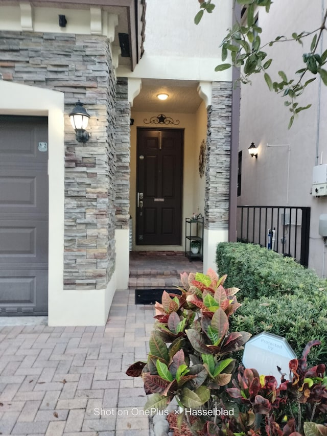 doorway to property with a garage