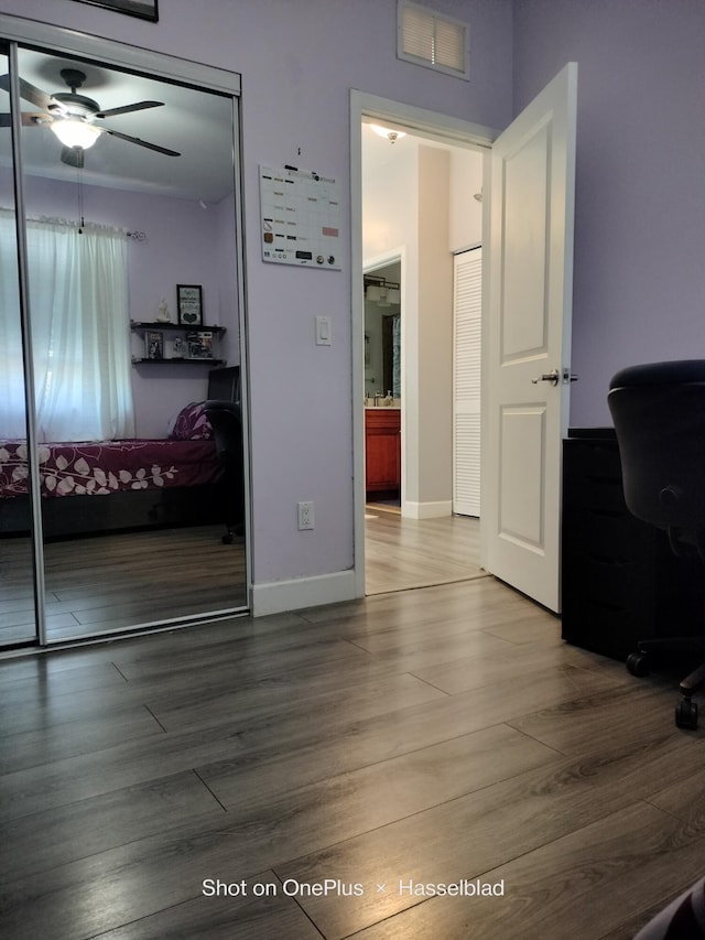 interior space featuring hardwood / wood-style flooring, ceiling fan, and a closet