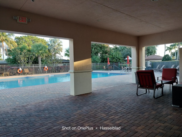 view of pool with a playground and a patio area