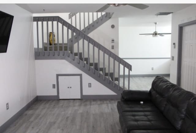 living room with hardwood / wood-style flooring and ceiling fan