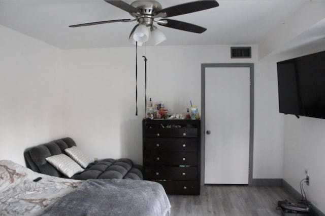 bedroom featuring hardwood / wood-style flooring and ceiling fan