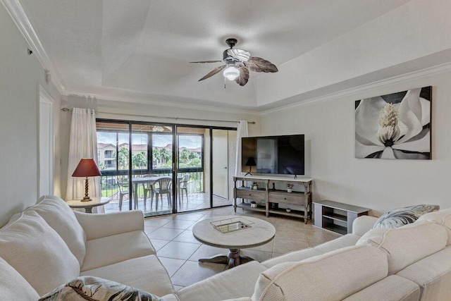 tiled living room featuring ornamental molding, ceiling fan, and a tray ceiling